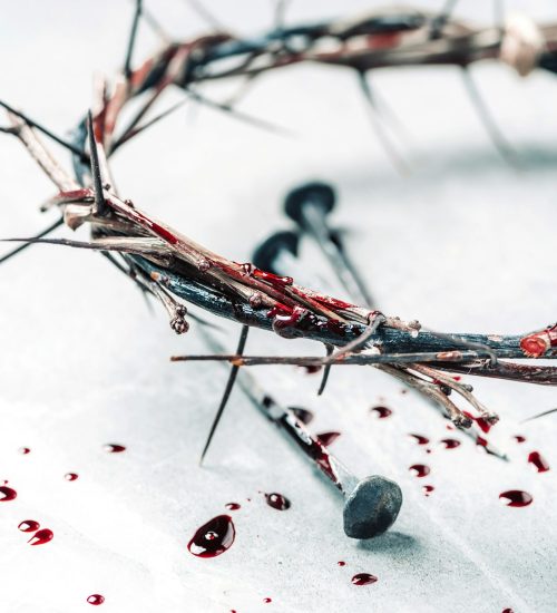 Crown of thorns with blood dripping, nails on stone. Christian concept of Jesus Christ suffering